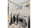 Laundry room with washer, dryer, and shelving at 12931 Twin Bridges Dr, Riverview, FL 33579