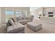 Open living area with a comfortable sectional sofa and ottoman at 12931 Twin Bridges Dr, Riverview, FL 33579