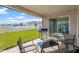 Covered patio with seating, grill, and backyard view at 12931 Twin Bridges Dr, Riverview, FL 33579