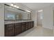 Large bathroom with double vanity, granite countertop and walk-in shower at 1317 Lorea Ln, Brandon, FL 33511