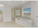 Bathroom with a large soaking tub, shower, and window at 1317 Lorea Ln, Brandon, FL 33511