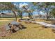 Picnic area with tables, grill, and benches under shade trees at 1317 Lorea Ln, Brandon, FL 33511