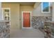Attractive orange front door with stone accents at 1317 Lorea Ln, Brandon, FL 33511