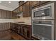 Well-equipped kitchen with stainless steel appliances and dark wood cabinets at 1317 Lorea Ln, Brandon, FL 33511