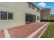 Red paver patio with screened enclosure attached to house at 1317 Lorea Ln, Brandon, FL 33511