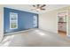 Primary bedroom with blue accent wall and ensuite bath at 13214 Moran Dr, Tampa, FL 33618