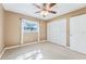 Spacious bedroom with ceiling fan and mirrored closet doors at 13214 Moran Dr, Tampa, FL 33618