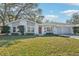 Charming single-story home with gray siding, red door, and attached garage at 13214 Moran Dr, Tampa, FL 33618