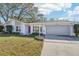 Landscaped front yard with spacious driveway and house exterior at 13214 Moran Dr, Tampa, FL 33618
