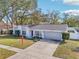 Charming house with a red door and grey exterior at 13214 Moran Dr, Tampa, FL 33618