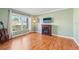 Living room featuring hardwood floors, fireplace, and large window at 13214 Moran Dr, Tampa, FL 33618