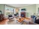 Virtually staged living room with fireplace and hardwood floors at 13214 Moran Dr, Tampa, FL 33618