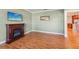 Living room with hardwood floors and fireplace, open to kitchen at 13214 Moran Dr, Tampa, FL 33618