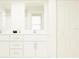 Clean bathroom with double vanity, white cabinets, and large mirror at 15233 Rainbow Quartz St, Wimauma, FL 33598