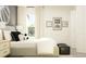 Bright bedroom featuring a light gray bed and neutral decor at 15233 Rainbow Quartz St, Wimauma, FL 33598