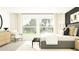 Bright bedroom with large windows, plush bed, and stylish decor at 15233 Rainbow Quartz St, Wimauma, FL 33598