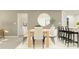 Bright dining room with light wood table and six off-white chairs at 15233 Rainbow Quartz St, Wimauma, FL 33598