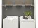 Laundry room with washer, dryer, and overhead shelving for storage at 15233 Rainbow Quartz St, Wimauma, FL 33598