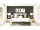 Spacious main bedroom with a gray upholstered bed and stylish decor at 15233 Rainbow Quartz St, Wimauma, FL 33598
