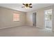 Primary bedroom with ceiling fan, window blinds, and carpet at 1628 Baker Rd, Lutz, FL 33559