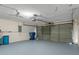 Garage with overhead storage and painted floor at 1628 Baker Rd, Lutz, FL 33559