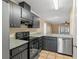 Kitchen features granite countertops, dark cabinets, and stainless steel appliances at 1628 Baker Rd, Lutz, FL 33559