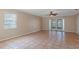 Bright living room featuring tile floors and sliding doors at 1628 Baker Rd, Lutz, FL 33559