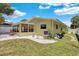 Green house exterior with a side yard and white fence at 1742 Mississippi Ne Ave, St Petersburg, FL 33703