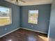 Spacious bedroom with light blue walls and laminate wood flooring at 21480 Olean Blvd, Port Charlotte, FL 33952