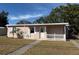 Ranch-style home with white picket fence and mature landscaping at 21480 Olean Blvd, Port Charlotte, FL 33952