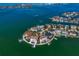 Aerial view of waterfront homes on a beautiful tropical peninsula at 26 Sunset Bay Drive, Belleair, FL 33756