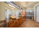 Well-lit bathroom featuring double sinks, wood cabinetry and glass enclosed shower at 26 Sunset Bay Drive, Belleair, FL 33756