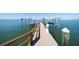 Residential wooden dock with boat lifts on the water at 26 Sunset Bay Drive, Belleair, FL 33756