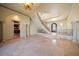 Grand foyer featuring tile flooring, arched doorways, elegant staircase, and a decorative chandelier at 26 Sunset Bay Drive, Belleair, FL 33756