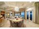 Elegant living room with chandelier, water view, and neutral tones at 26 Sunset Bay Drive, Belleair, FL 33756