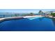 Beautiful backyard pool with a water view and lounging areas at 26 Sunset Bay Drive, Belleair, FL 33756