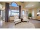 Comfortable sitting area with water view, custom window treatment, and neutral decor at 26 Sunset Bay Drive, Belleair, FL 33756