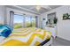 Bedroom with yellow chevron comforter and balcony access at 2700 Bayshore Blvd # 11302, Dunedin, FL 34698