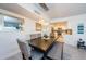 Bright dining room with dark wood table and modern light fixture at 2700 Bayshore Blvd # 11302, Dunedin, FL 34698
