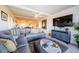 Living room with sectional sofa, large TV, and access to dining area at 2700 Bayshore Blvd # 11302, Dunedin, FL 34698