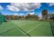 Community tennis court with a green surface and surrounding fence at 2700 Bayshore Blvd # 11302, Dunedin, FL 34698