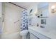 Bathroom with shower/tub combo and coastal decor at 2700 Bayshore Blvd # 4309, Dunedin, FL 34698