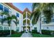 Two-story condo building with palm trees and walkway at 2700 Bayshore Blvd # 4309, Dunedin, FL 34698