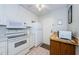 Clean kitchen featuring white appliances and wood counter at 2700 Bayshore Blvd # 4309, Dunedin, FL 34698