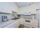 Efficient kitchen with white cabinets, microwave, and dishwasher at 2700 Bayshore Blvd # 4309, Dunedin, FL 34698