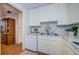 Neat kitchen with white cabinets, and built-in microwave at 2700 Bayshore Blvd # 4309, Dunedin, FL 34698