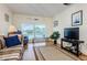 Living room with TV, seating, and view from window at 2700 Bayshore Blvd # 4309, Dunedin, FL 34698
