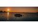 Stunning sunset over calm water with a boat at 2700 Bayshore Blvd # 4309, Dunedin, FL 34698