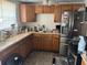 Kitchen featuring wood cabinets, stainless steel refrigerator, and ample counter space at 3416 N 48Th St, Tampa, FL 33605