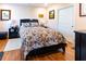 Spacious bedroom with a floral comforter and wood floors at 3653 Kings Rd # 101, Palm Harbor, FL 34685